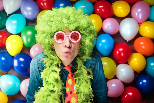 Mann in Karnevalstimmung auf einem Hintergrund aus bunten L&uuml;ftballons 