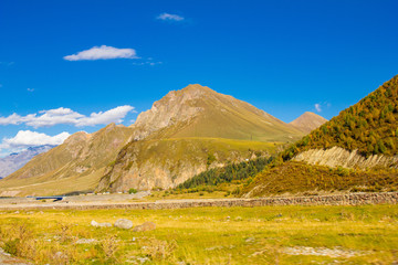Fototapeta premium Beautiful view of the landscape of the Georgian military road on a Sunny summer day. The road connects the city of Vladikavkaz, Russia and Tbilisi, Georgia.