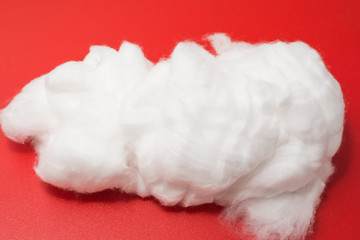 medical cotton on a red background close-up