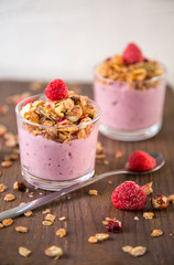 Granola with fresh berry in glass with yoghurt