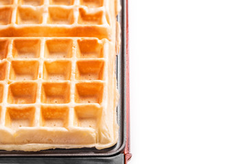 Freshly prepared belgian waffles on white background with copyspace