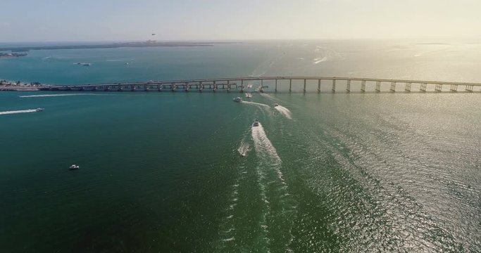 Aerial view of bridge and boats on the ocean, Miami. Light effect