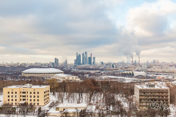Urban landscape. Winter cloudy day. Smoke from the pipes of the combined heat and power plant....