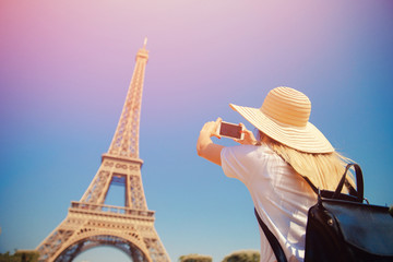 Fototapeta na wymiar Girl tourist Eiffel tower making selfie. Beautiful European enjoying vacation in Paris, France. Concept travel