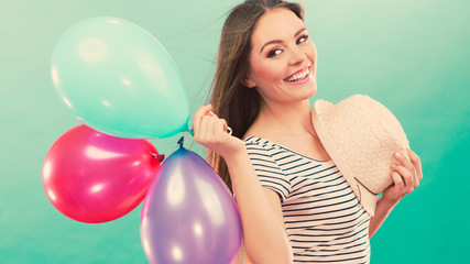 Happy girl playing with colorful balloons.