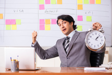 Young handsome employee working in the office