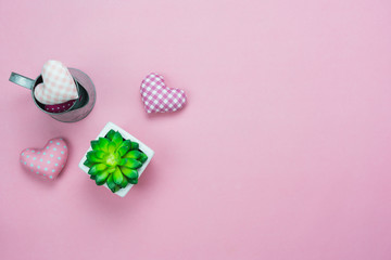 Table top view aerial image of decoration valentine's day & earth day background concept.Flat lay essential items green tree pot and colorful love shape on modern pink paper.blank space for mock up.