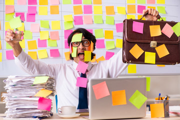 Young employee in conflicting priorities concept 