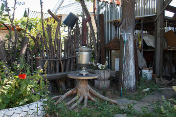 Household utensils. The mess in the yard. Samovar in the center