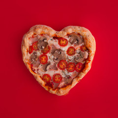 Pizza heart shaped on red