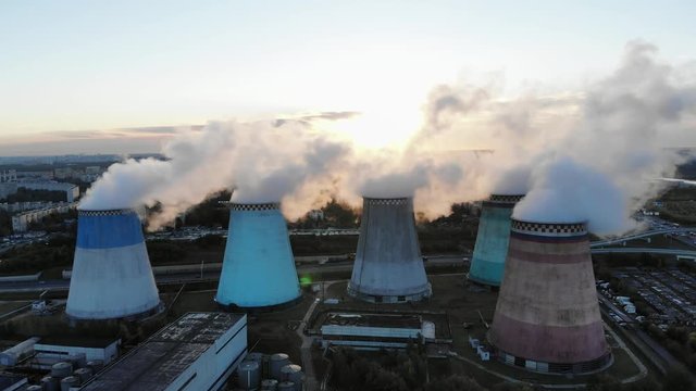 Power plant block. Cooling tower. Water vapor rises to the sky. Footage. Aerial view. Sunrise and fog. 4K.