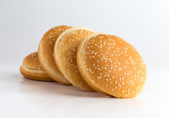 Burger buns on white background. A few buns cut in half close up on a white background.