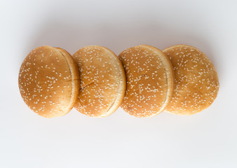 Burger buns on white background. A few buns cut in half close up on a white background.