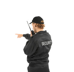 Male security guard with portable radio transmitter on white background