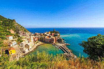 Naklejka premium View over the beautiful colourful houses on the mountains over the Mediterranean Sea and the harbour of Cinque Terre, Italy.