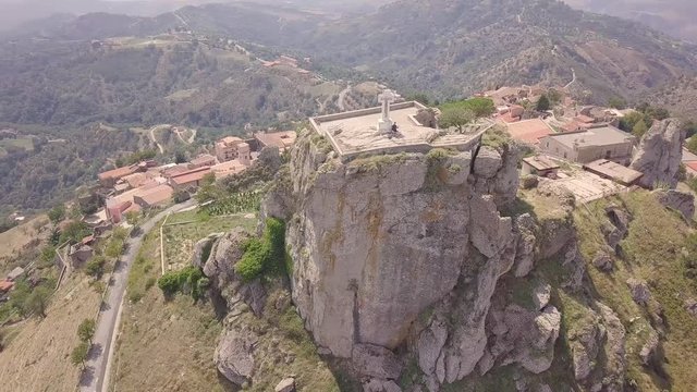 Stunning orbit 4k drone aerial footage around the rock and Catholic cross in Bova, a small Italian village in the hills in Calabria