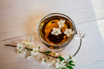 Tea. green. Herbal. Mint. Tea with apple flavor. in a glass cup with an apple flower and dried tea...
