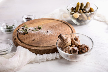 Fototapeta na wymiar Bowl with tasty fermented mushrooms on light table