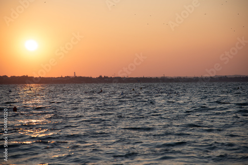 Beautiful Sunset On The Lake With Skyline On The City