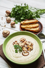 Bowl of tasty hot soup on white table
