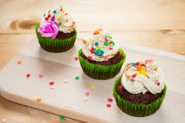 Chocolate muffin on a wooden chalkboard. Three muffins on the board. backround. view from above