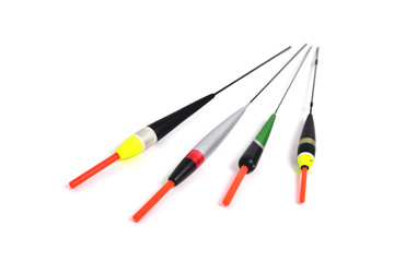 fishing floats of different shapes and colors on a white background close-up, copy space © Александр Юркевич