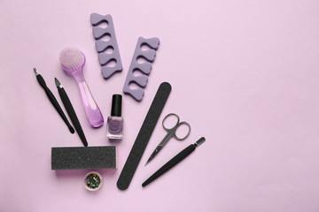 Set of pedicure tools on color background