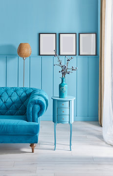 Blue room, armchair and orange lamp style with frame and picture.