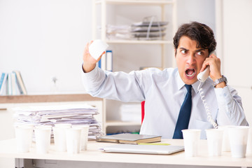 Young employee addicted to coffee