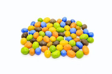 Bright multicolored glazed chocolate candies on white