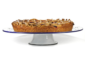 cherry cake on an enamel plate isolated on white background