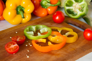 kitchen wooden Board with sliced juicy bright vegetables