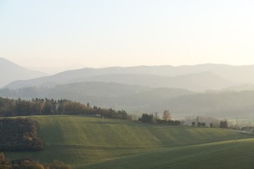 Naklejka na ściany i meble Misty morning on meadow with trees and views. Slovakia