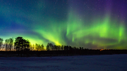 Northern lights above the lake in Lapland