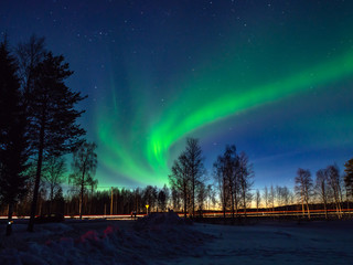 Northern lights above the road in Finnish Lapland