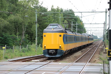 Intercity train between utrecht and zwolle at railroad track at station 't Harde.