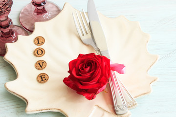 Festive table setting on a light wooden background. Valentine's day concept.