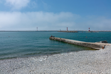 Fototapeta na wymiar Fishermen on the pier on a clear day
