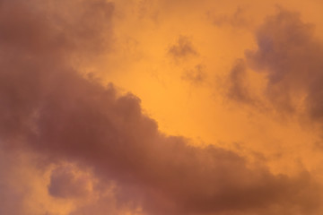 Dramatic clouds at colourful moody sunset