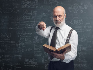 Academic professor holding a book and pointing