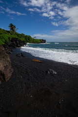 Black sand beach on road to Hana in Maui Hawaii