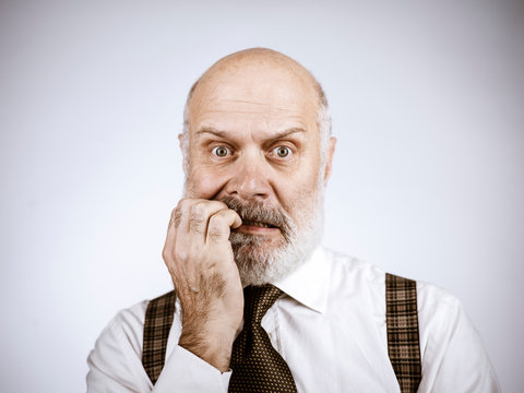 Nervous anxious senior man biting his nails