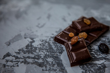 Chocolate with dried fruits: raisins and cranberries. copy space