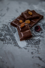 Chocolate with dried fruits: raisins and cranberries. copy space