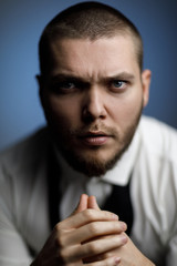 young bearded man in a white shirt and bow tie