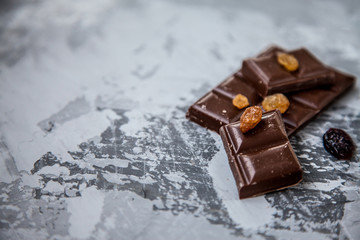 Chocolate with dried fruits: raisins and cranberries. copy space