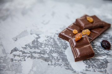 Chocolate with dried fruits: raisins and cranberries. copy space