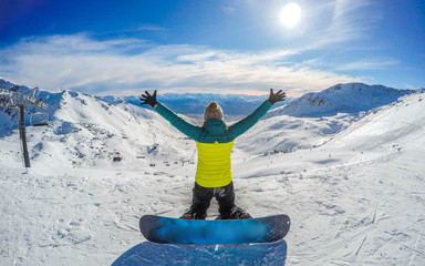 Winter sport activity.Woman holding snowboard, overlooking mountain landscape freedom, enjoying a...