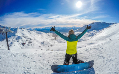 Winter sport activity.Woman holding snowboard, overlooking mountain landscape freedom, enjoying a winter, cold season. Having fun on the snow, mountains, ski area, Remarkables, New Zealand, Queenstown
