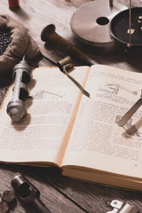 The process of reloading hunting cartridges. On the book are the measurements, twist and fraction...